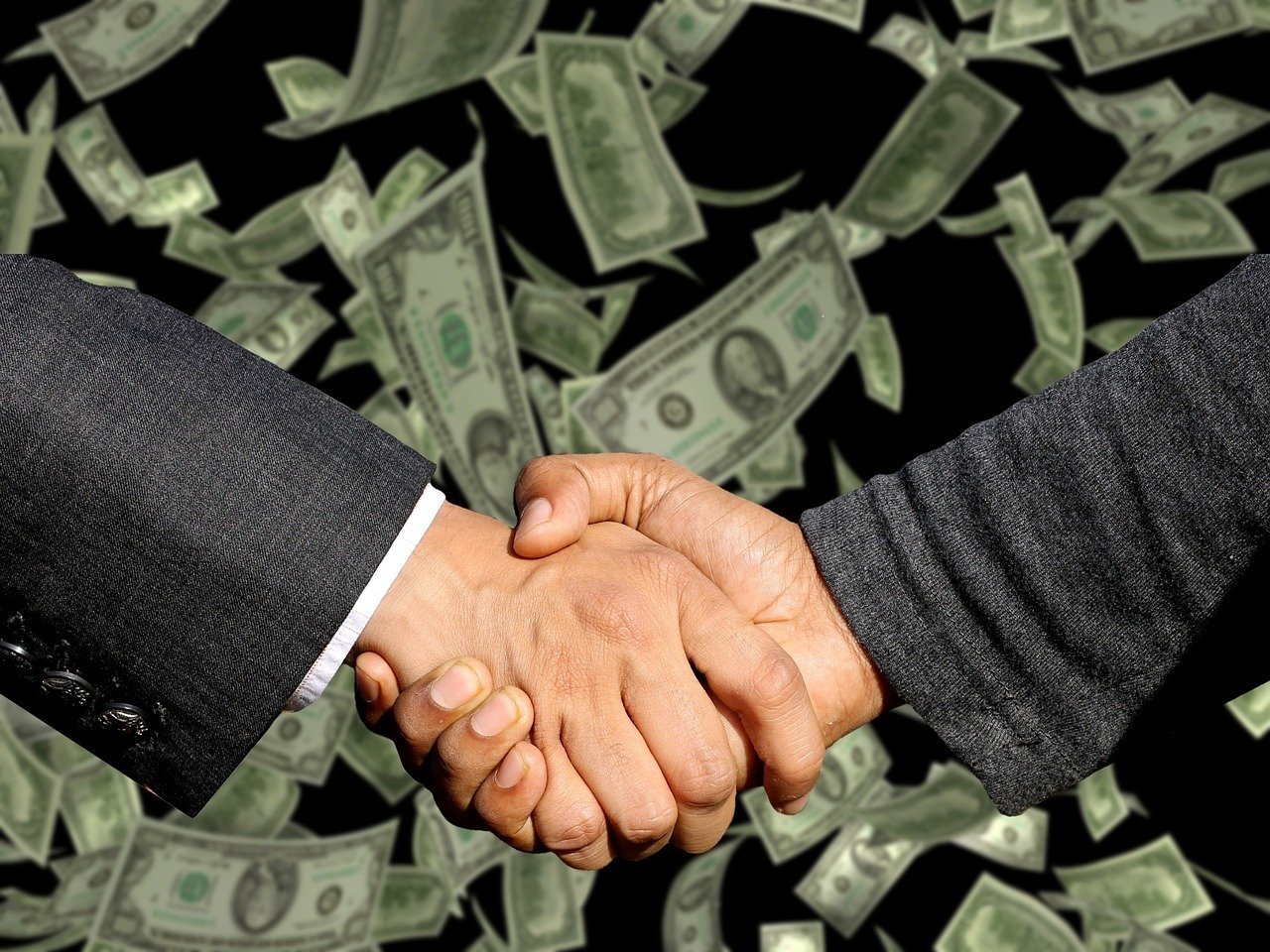 Two hands shaking over a digital contract representing off-chain agreement